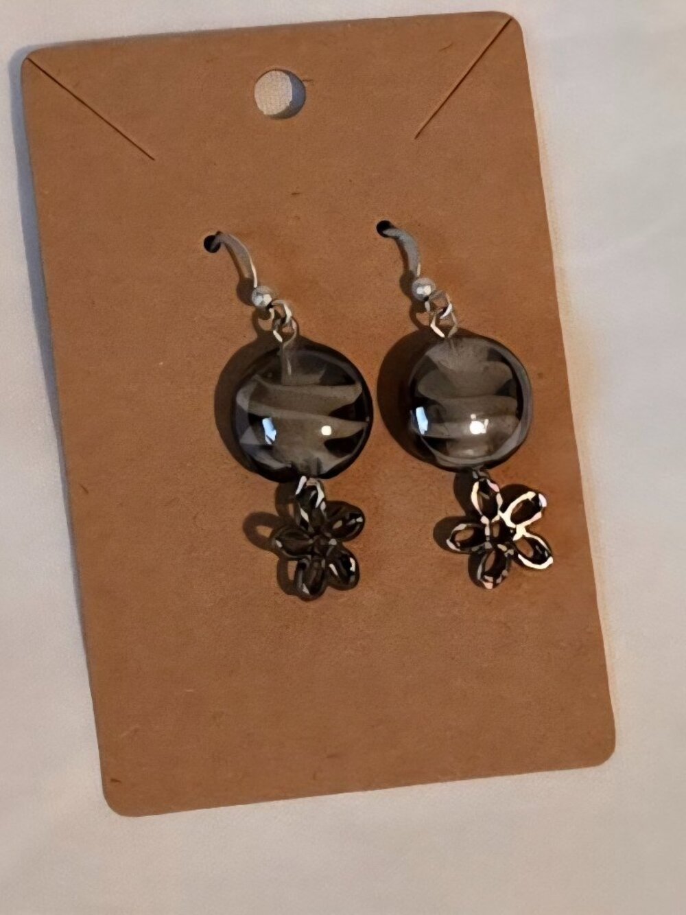 Silver tone dangle earrings with glass bead